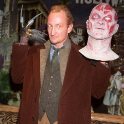 Robert Englund posing with Freddy Krueger mask