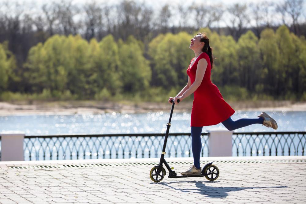 image of a woman riding a scooter