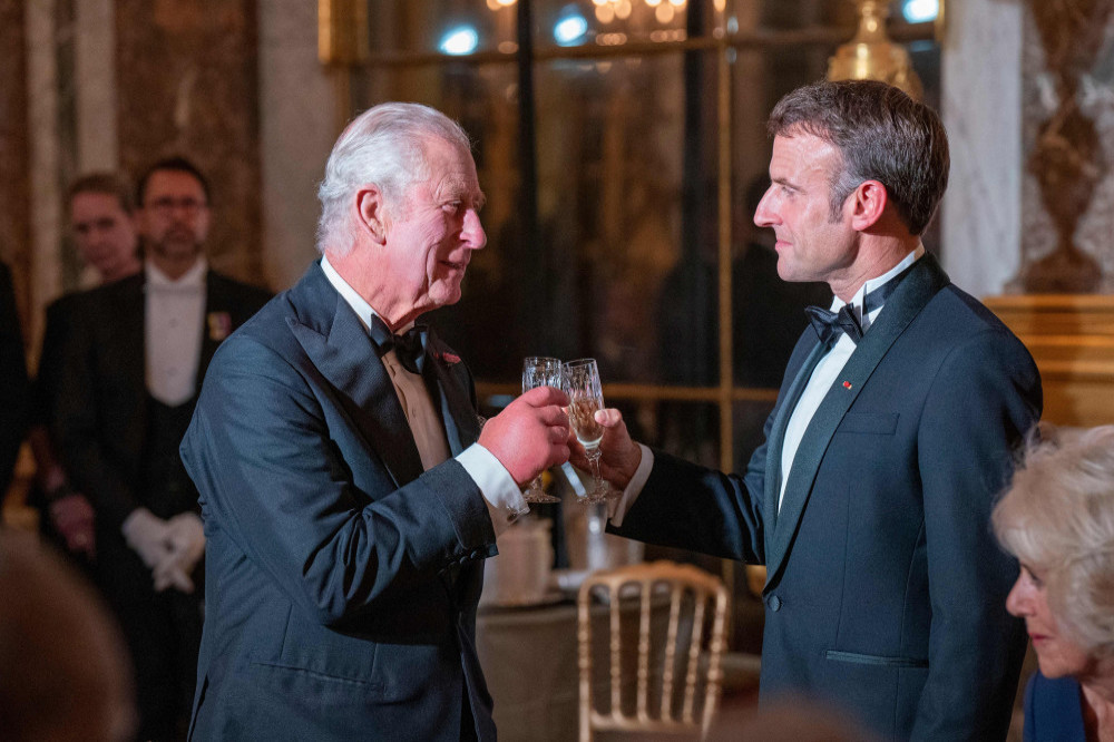 King Charles raises a toast with President Macron