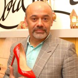 Christian Louboutin with one of his designs